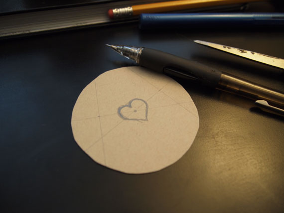 then i drew a heart shape in the middle (could be other shapes). i used an old geometry trick that i remembered! draw two rays and draw a perpendicular line in the middle of those rays, and where those lines intersect is where the center is...MATHS!