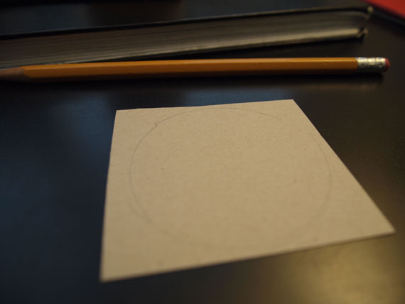 that other piece of cardboard, cut a circle the same size as your lense